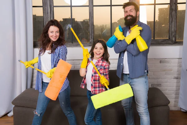 Expert house cleaning service you can trust. Family cleaning house. Happy family hold cleaning products. Mother, father and daughter cleaning house. Clean house. Everything should be perfect