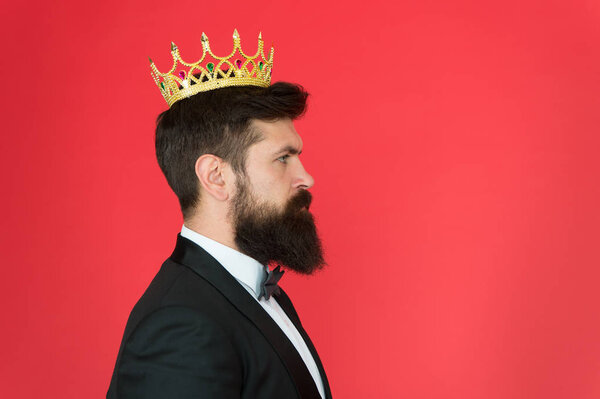 King attribute. Narcissistic king. Self confidence concept. Handsome hipster formal suit. Elite society. Feeling superior. Man bearded guy in tuxedo golden crown symbol of monarchy. King ceremony