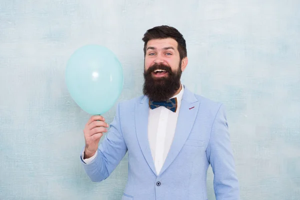 Lets have fun. Man groom blue tuxedo bow tie hold air balloon. Wedding fun. Groom bearded hipster having fun with air balloon. My happy day. Happy guy in cheerful mood. Fun and happiness concept