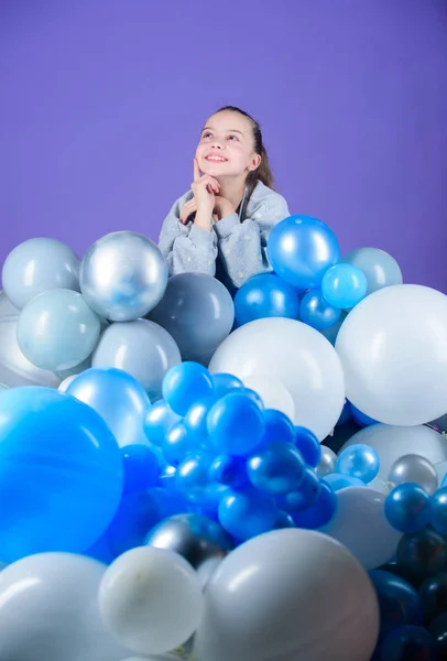 Having fun. Balloons theme party. Girl between air balloons. Birthday party. Childrens day. Carefree childhood. All those balloons for me. Happiness positive emotions. Obsessed with air balloons