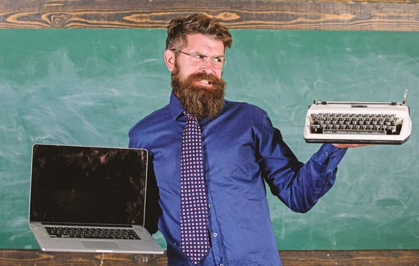 Choose right teaching method. Digital against retro. Modern technologies benefit. Modern instead outdated. Teacher bearded hipster holds typewriter and laptop. Teacher choosing teaching approach