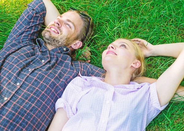 Nature fills them with freshness and peace. Man unshaven and girl lay on grass meadow. Guy and girl happy carefree enjoy freshness of grass. Closer to nature. Couple in love relaxing lay at meadow — Stock Photo, Image