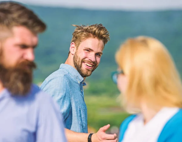 Man with beard jealous aggressive because girlfriend interested in handsome passerby. Husband strictly watching his wife looking at another guy while walk. Jealous concept. Passerby smiling to lady