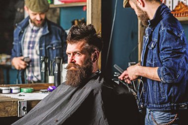 Acımasız sakallı istemci kesme makinesi styling saç ile berber. Hipster istemci Başlarken saç kesimi. Hipster yaşam tarzı kavramı. Kuaför saç kesme makinesi ile saç modeli sakallı adam berber arka plan için çalışır