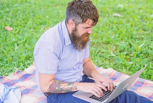 Hipster blogger with laptop nature background. Blogger create content for social network. Writer or blogger write post for social network. Creativity crisis. Blogger thoughtful face create content