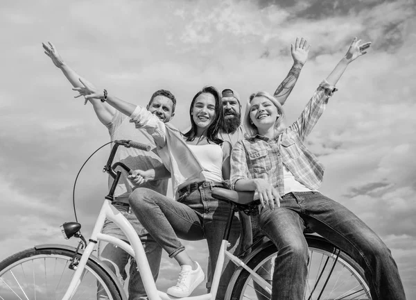 Company stylish young people spend leisure outdoors sky background. Bicycle as part of life. Cycling modernity and national culture. Group friends hang out with bicycle. Share bike live eco friendly