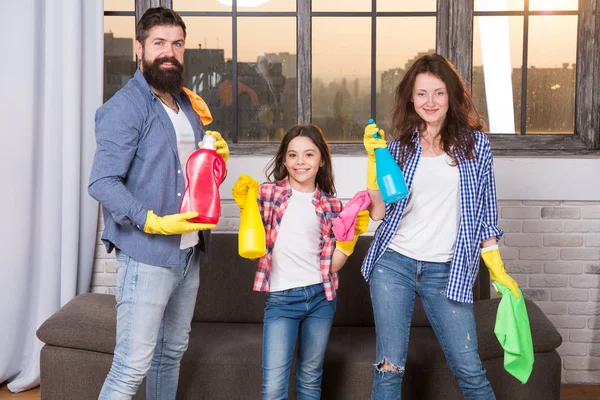 I can totally make that. Just Like Home. Professional Service. Family clean house. Happy family hold cleaning products. Clean your way of life. Mother, father and daughter clean house. Perfect team — Stock Photo, Image