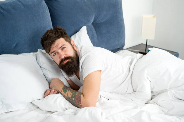 Guy lying in bed try to relax and fall asleep. Relaxation techniques. Violations of sleep and wakefulness. Need some rest. Sleep disorders concept. Man bearded hipster having problems with sleep