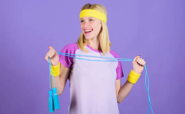 Girl hold jumping rope wear bright wristbands. Weight loss concept. Woman exercising with jumping rope. Jumping exercise benefits. Proper approach to lose weight. Jumping rope is great calorie burner