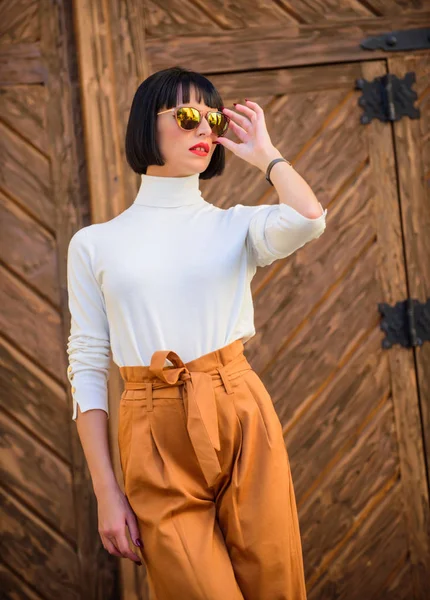 Fashionable outfit slim tall lady. Woman walk in elegant outfit. Fashion and style concept. Woman fashionable brunette stand outdoors wooden background. Girl with makeup posing in fashionable clothes