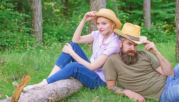 Choose proper clothing and equipment to hike and forest picnic. Couple in straw hats sit meadow relaxing. Reasons you should definitely wear more hats. Wearing sun hats protect head and hair from sun