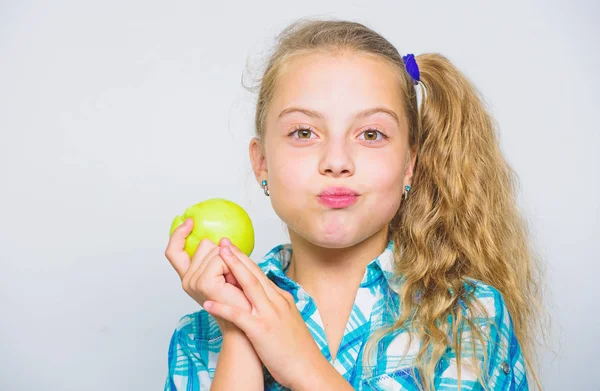 Good nutrition is essential to good health. Kid girl eat green apple fruit. Nutritional content of apple. Vitamin nutrition concept. Reasons eat apple every day. Apple a day keeps doctor away