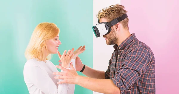 Video game captured imagination of guy. Wife tries to help him back into real life. Man VR glasses involved video game while girl try to wake him up. Video game addiction symptoms and treatment