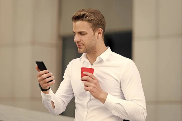 Check emails. Man drinks coffee checking emails in morning urban background. Strat great day. Businessman relaxing with coffee morning time. Guy handsome attractive businessman needs energy charge