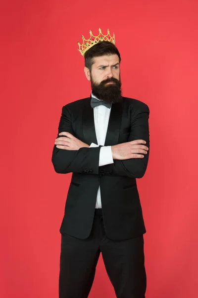Self confidence concept. Handsome hipster formal suit. Feeling superior. Man bearded handsome guy in formal suit golden crown symbol of monarchy. King on this event. King attribute. Narcissistic king