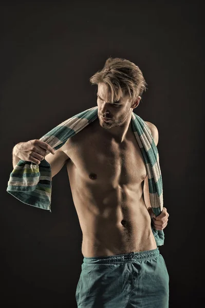 Sexy sportsman wipe with towel after training. Man with fit bare torso. Athlete with six pack and ab muscles. Sport and fitness. Hygiene or health and bodycare concept, vintage filter — Stock Photo, Image