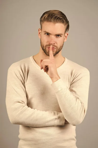 Keep silence. Man handsome attractive silence gesture. You better keep our secret. Being entrusted with secret can be both delight and burden. Guy asks to keep his secret