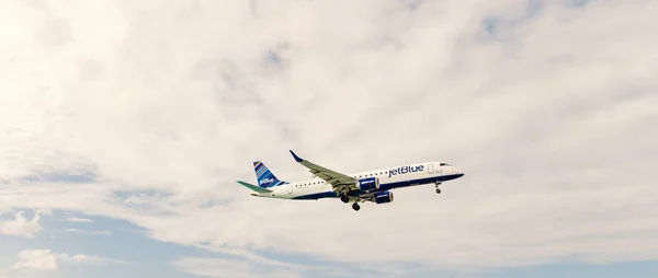 Philipsburg, Sint Maarten - January 24, 2016: jet on flight in clouds. Aircraft fly on cloudy sky. Plane on sunny day. Travel by air transport, aviation. Wanderlust, vacation and trip — Stock Photo, Image