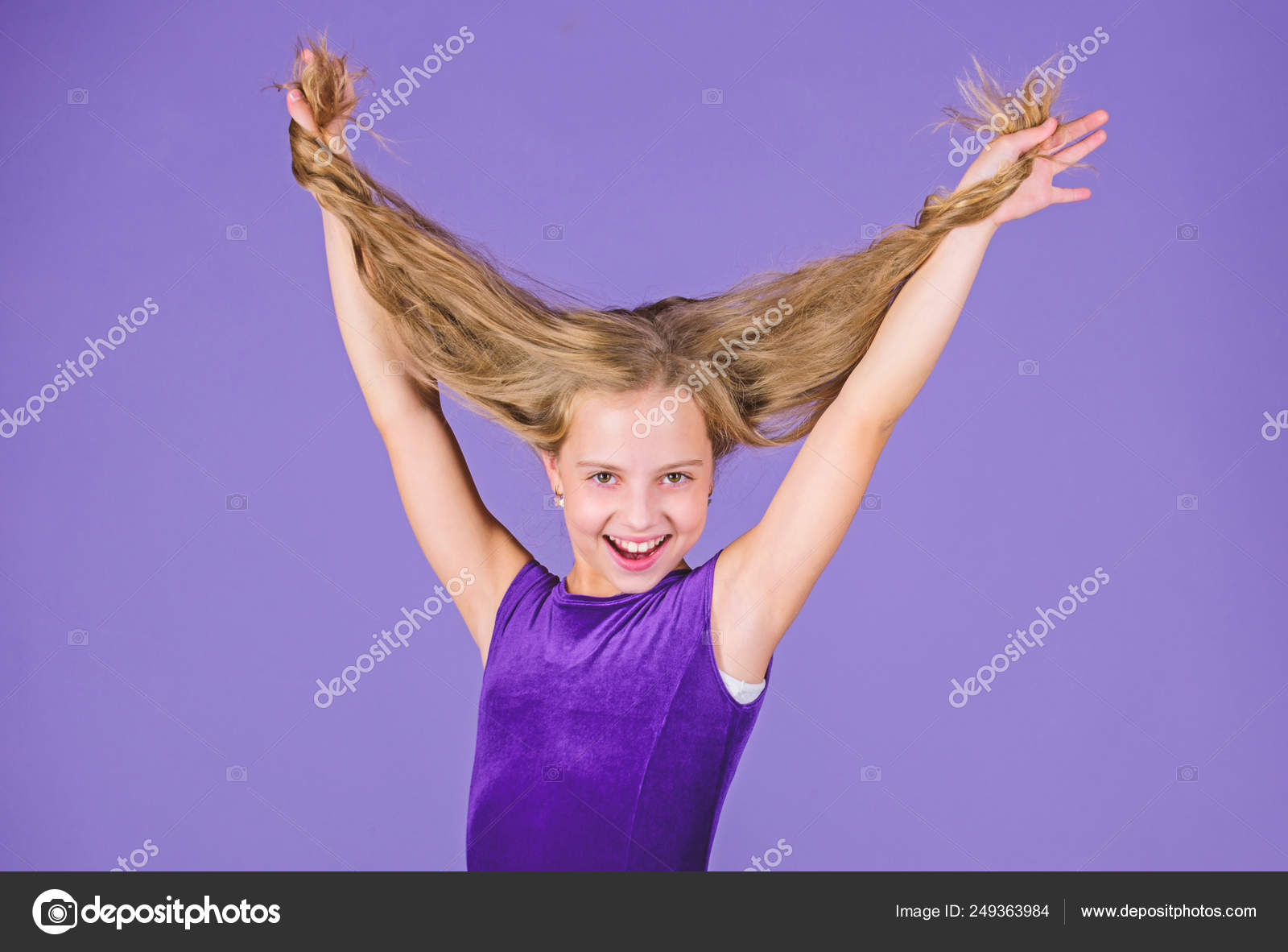 Kid Girl With Long Hair Wear Dress On Violet Background