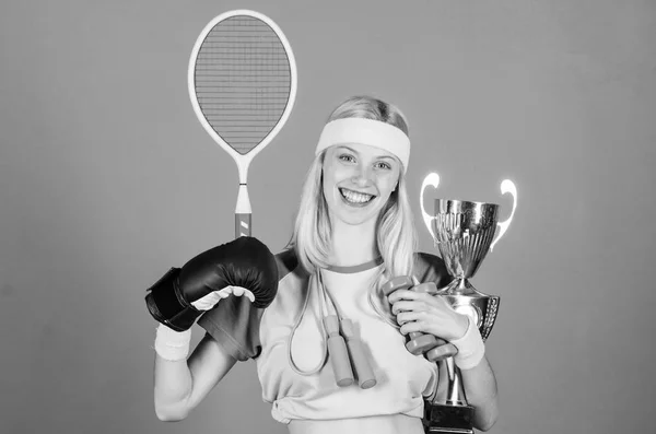 How to find time for everything. Sport champion. Fitness champion. Champion concept. Girl successful modern woman hold golden goblet of champion. Woman good in tennis jumping boxing fitness sport — Stock Photo, Image