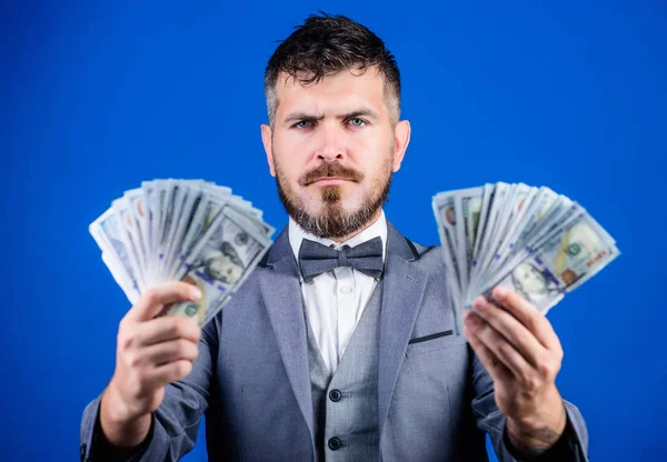 Ensuring his financial future. Bearded man hold cash money. Currency broker with bundle of money. Making money with his own business. Business startup loan. Rich businessman with us dollars banknotes