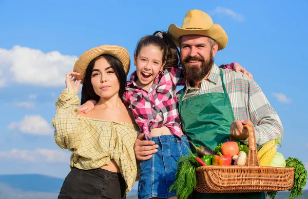 Family happy cheerful farmers gardeners. Family farmers proud of fall harvest. Harvest festival concept. Life in countryside benefits. Parents and daughter rustic style farmers on blue sky background — Stock Photo, Image