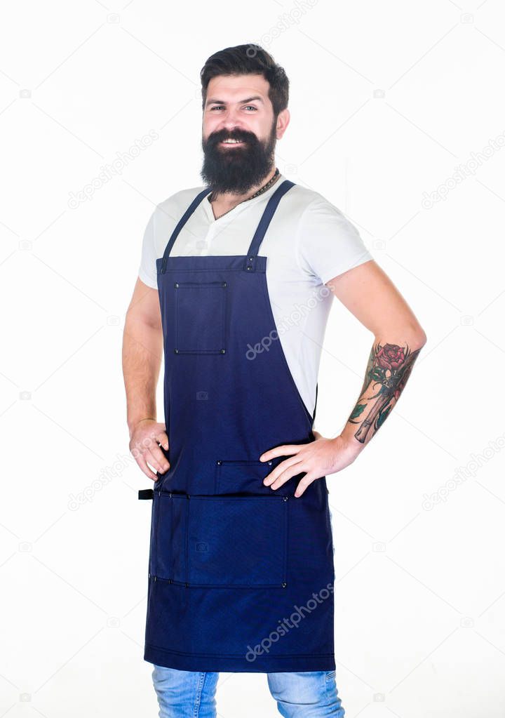 Apron for true guy at the grill. Master of grill in cooking apron with pockets. Bearded man in kitchen apron. Stylish grill cook keeping hands on hips. Cook with long beard wearing bib apron