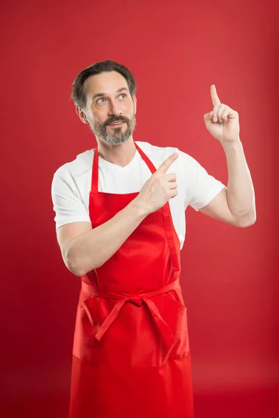 A inventar um novo prato. Cozinhe com barba e bigode use avental fundo vermelho. Homem cozinheiro maduro posando avental de cozinha. Chefe cozinheiro e culinária profissional. Cozinhe comida em casa. Bela receita. Ideias e dicas — Fotografia de Stock