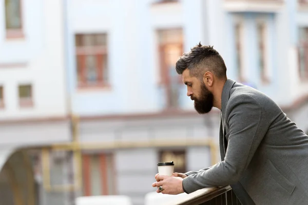 Life begins after coffee. Bearded man enjoying morning coffee. Businessman in hipster style holding takeaway coffee. The best time of day to drink coffee. Hipster with paper cup walking in city — Stock Photo, Image