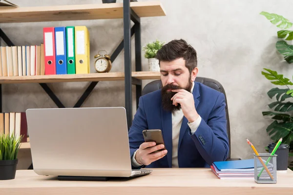 Developing business strategy. Risky business. Surfing internet. Man bearded boss manager sit office with laptop. Manager solving business problems. Businessman in charge successful business solutions