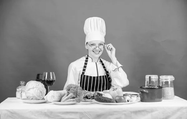 Woman chef cooking healthy food. Culinary school concept. Female in apron knows everything about culinary art. Culinary education. Fresh vegetables ingredients for cooking meal. Culinary expert