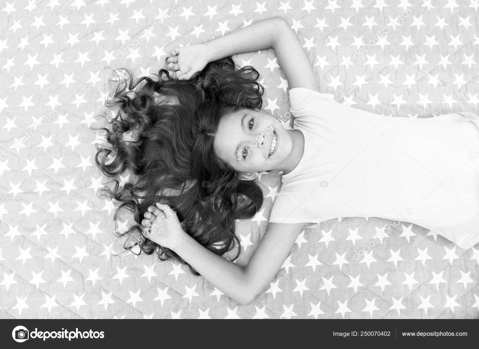 Girl Child With Long Hair Lay On Bed Top View Child Curly