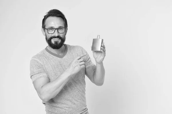 Man bearded handsome hold bottle perfume. How choose perfume for men according to occasion. Make sure smell fresh throughout day. Wearing perfume is enhancing mood. Amazing benefits of using perfumes — Stock Photo, Image