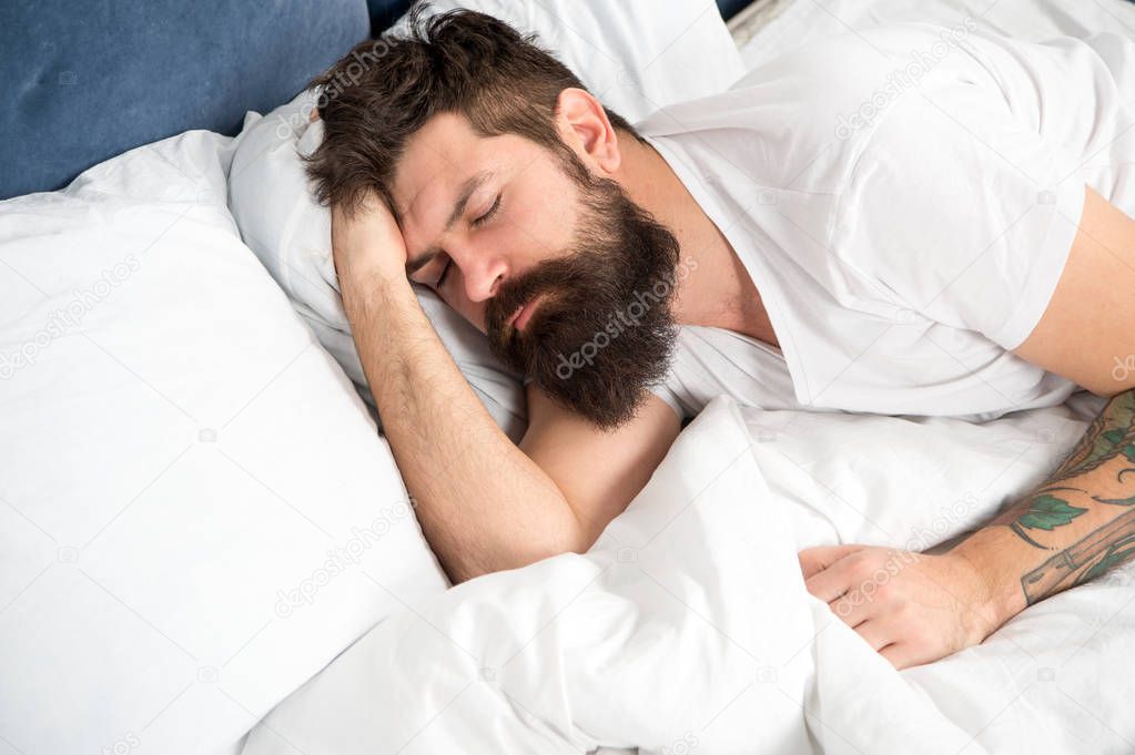 Sleep disorders concept. Man bearded hipster having problems with sleep. Guy lying in bed try to relax and fall asleep. Relaxation techniques. Violations of sleep and wakefulness. Need some rest