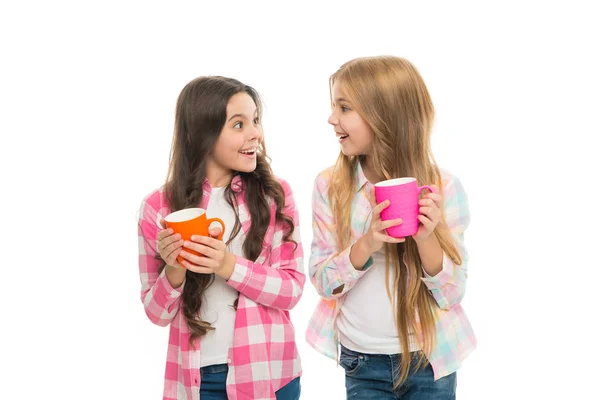 Hot cocoa recipe. Make sure kids drink enough water. Girls kids hold cups white background. Sisters hold mugs. Drinking tea juice cocoa. Relaxing with drink. Children drink enough during school day — Stock Photo, Image