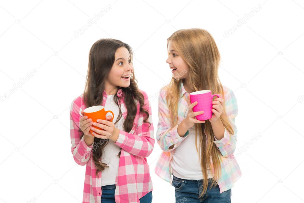 Hot cocoa recipe. Make sure kids drink enough water. Girls kids hold cups white background. Sisters hold mugs. Drinking tea juice cocoa. Relaxing with drink. Children drink enough during school day