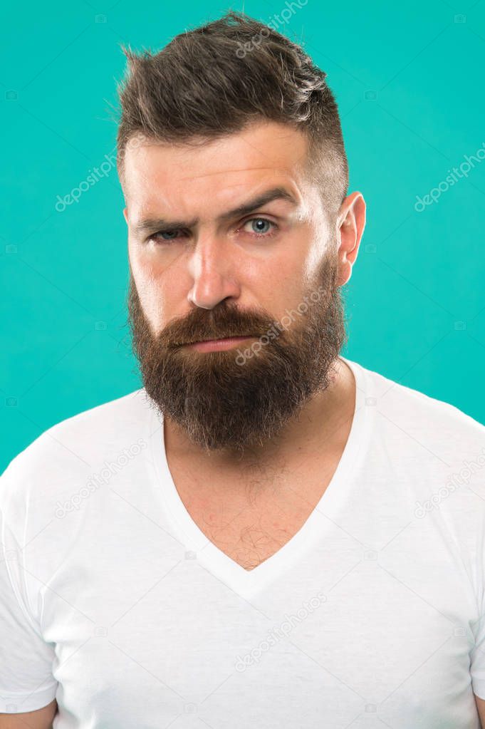 Beard fashion and barber concept. Strict and serious. Man bearded hipster stylish beard turquoise background. Barber tips maintain beard. Stylish beard and mustache care. Hipster appearance