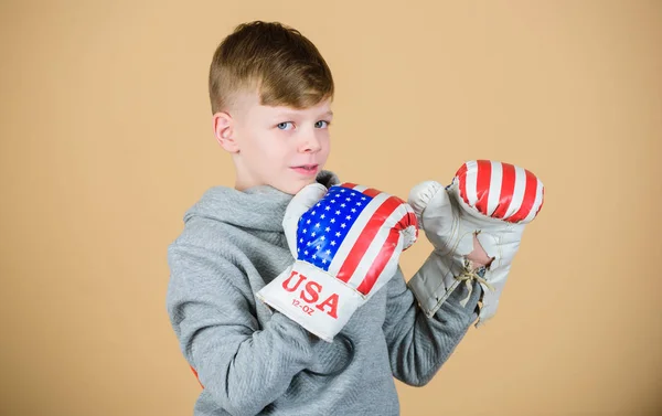 punching knockout. Fitness diet. energy health. Sport success. sportswear fashion. usa independence day. Happy child sportsman in boxing gloves. workout of small boy boxer. Feeling free and confident