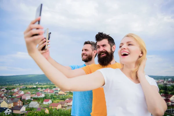 Girl and man with mobile smartphones communication online. Selfie time. Life online. People taking selfie or streaming online video. Mobile internet and social networks. Mobile dependency problem