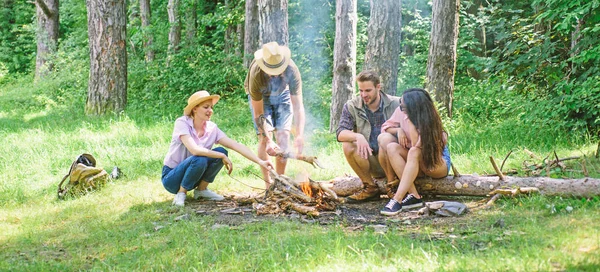 Hike barbecue. Friends enjoy weekend barbecue in forest. Company friends picnic or barbecue roasting food near bonfire. Best friends spend leisure weekend hike barbecue forest nature background