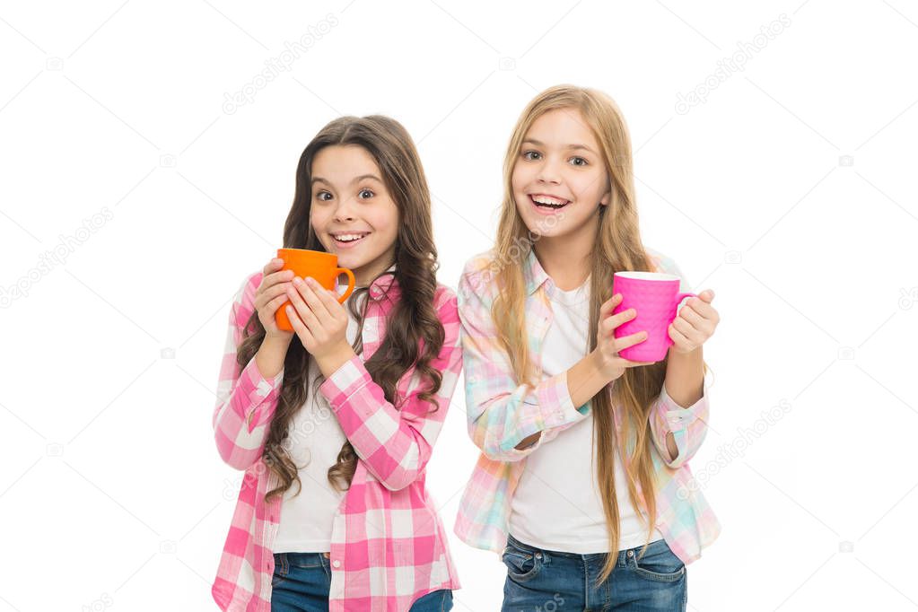 Hot cocoa recipe. Children drink enough during school day. Make sure kids drink enough water. Girls kids hold cups white background. Sisters hold mugs. Drinking tea juice cocoa. Relaxing with drink