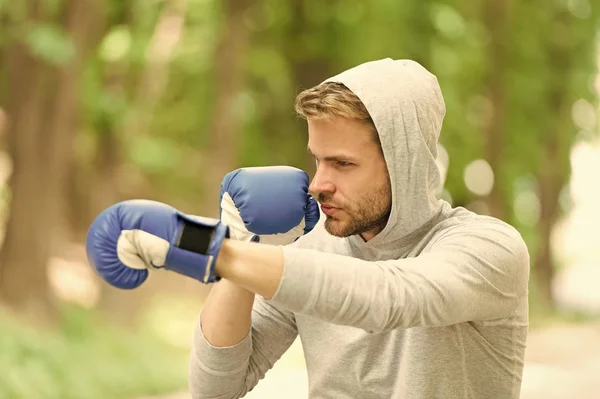 Attack or defend always be ready. Sportsman concentrated training boxing gloves. Athlete concentrated face sport gloves practice fighting skills nature background. Boxer handsome strict boxing — Stock Photo, Image