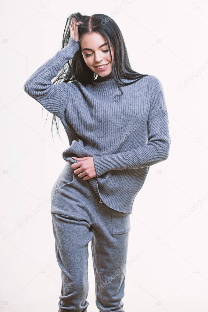 Fashionable knitwear. Female knitwear. Knitwear concept. Feel warm and comfortable. Woman wear grey textile suit blouse and pants. Warm comfortable clothes. Casual style fashion for every day