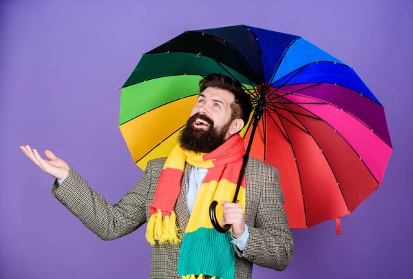 Looking like its going to rain. Autism. Autistic rain man holding colorful umbrella. Bearded man checking if it rains. Fashion man with colorful accessories. He never needs to worry about rainy days