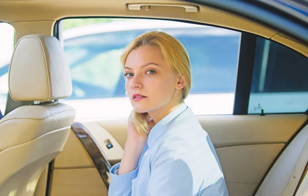 Business lady passenger luxury car salon. Personal assistant and driver. Business life concept. Business woman sit on backseat. Busy lady passenger leather car salon enjoy journey with chauffeur — Stock Photo, Image