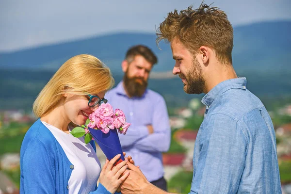 Couple in love dating while jealous husband fixedly watching on background. Couple romantic date lover present bouquet flowers. Unrequited love concept. Lovers meeting outdoor flirt romance relations — Stock Photo, Image