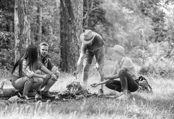 Företaget vänner laga rostade marshmallows mellanmål natur bakgrund. Camping aktivitet. Företaget ungdom camping skog rostning marshmallows. Rostning marshmallows populära gruppaktivitet runt bål — Stockfoto