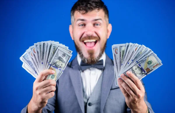 Making money with his own business. Bearded man holding cash money. Rich businessman with us dollars banknotes. Currency broker with bundle of money. Business startup loan. Boosting his income