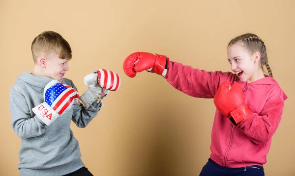 workout of small girl and boy boxer in sportswear. Happy children in boxing gloves. Fitness diet. punching knockout. Childhood activity. Sport success. Friendship fight. Work hard play hard