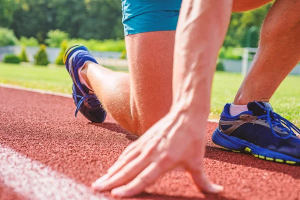 Starting point. Hand of sportsman on running track low start position. Runner ready to go close up. Ready steady go concept. At the beginning of great sport career. Hand touch track path close up — Stock Photo, Image